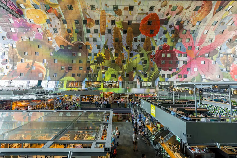 Rotterdam’s Markthal is a foodie’s paradise with a stunning ceiling mural.