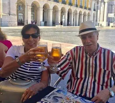 Expats Claudia and Rafael enjoy a beer on a terrace in their new home of Sintra, Portugal.