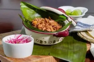 You can enjoy Maya-inspired dishes like cochinita pibil in well-regarded local restaurants like La Chaya Maya, La Tradición, or Restaurante Los Almendros.