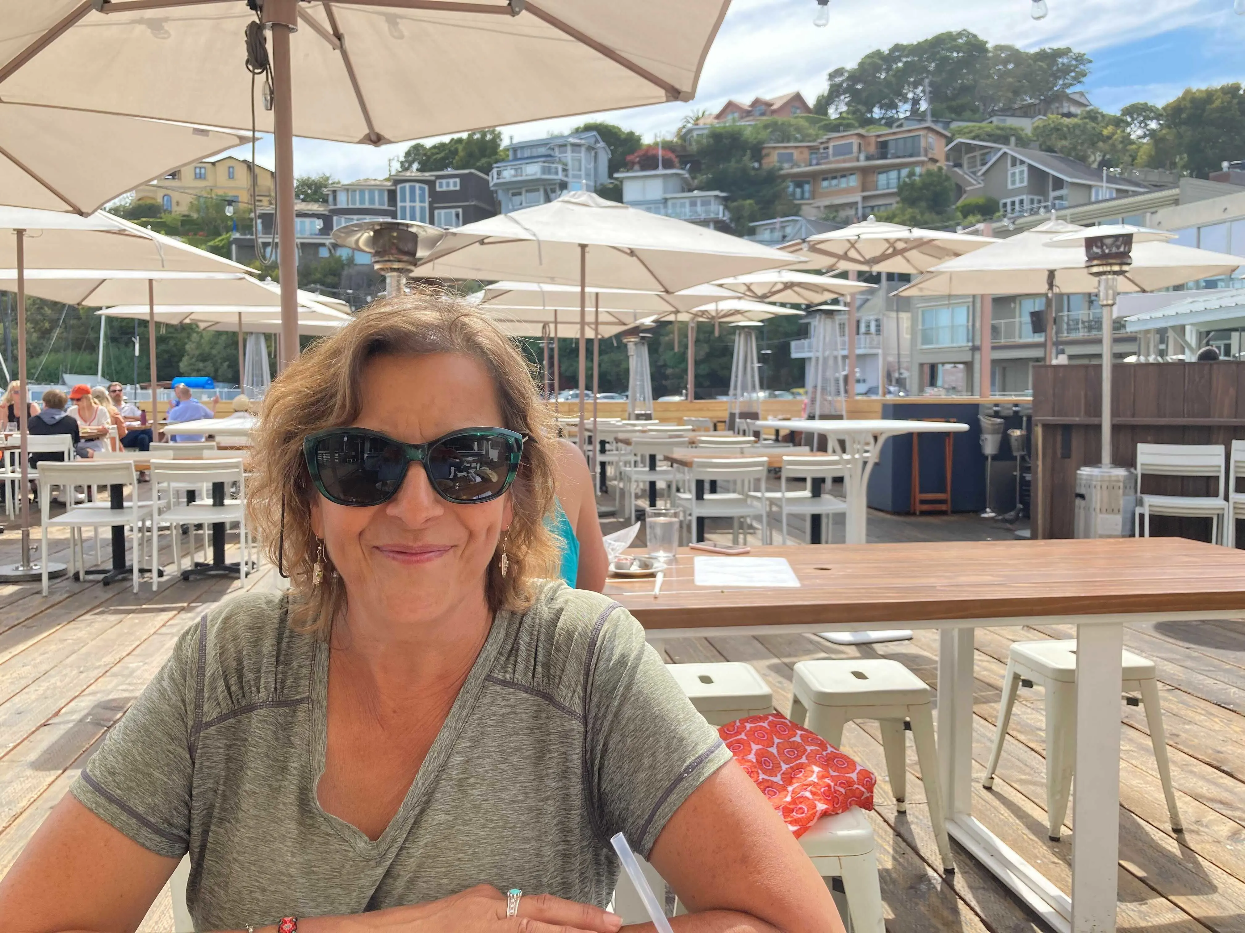 Cindy enjoys a sunny afternoon at a cozy outdoor café.