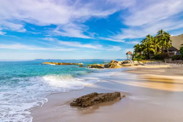 Recover under an umbrella on Conchas Chinas Beach in Puero Vallarta, Mexico.