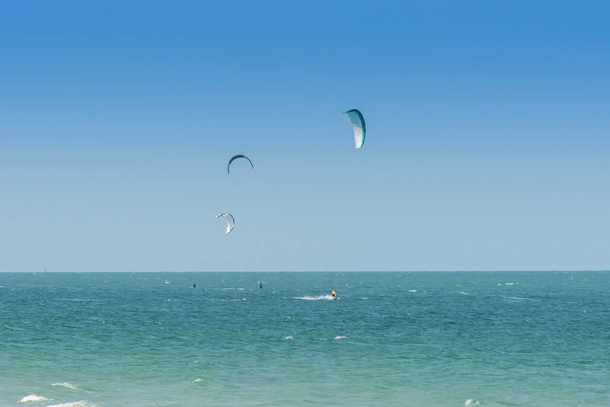 Kite surfers ride the waves in Hua Hin, a top spot in Thailand for thrilling water sports and seaside adventure.