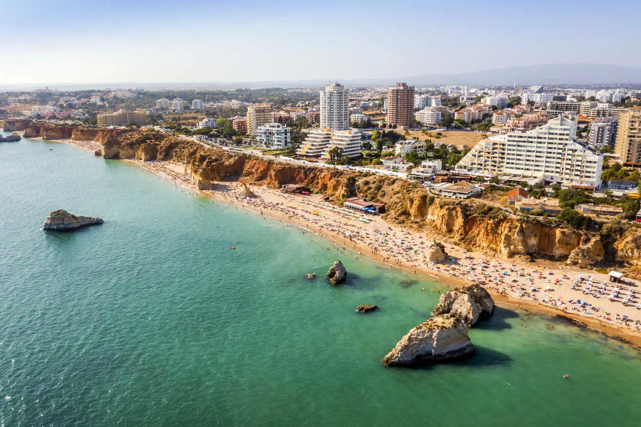 Golden cliffs and lively beach life in Praia da Rocha.