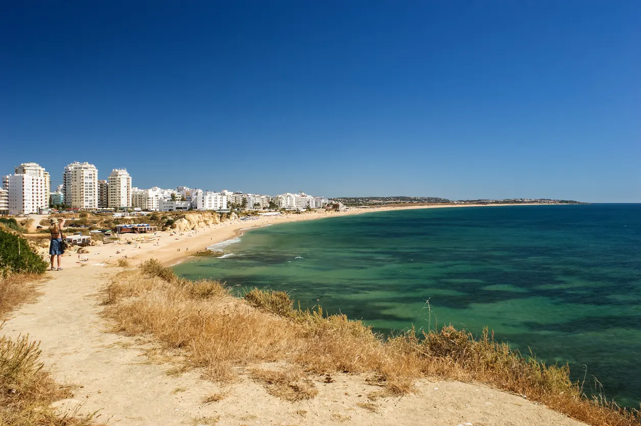 Algarve's Armação de Pêra offers serene beaches and local charm.