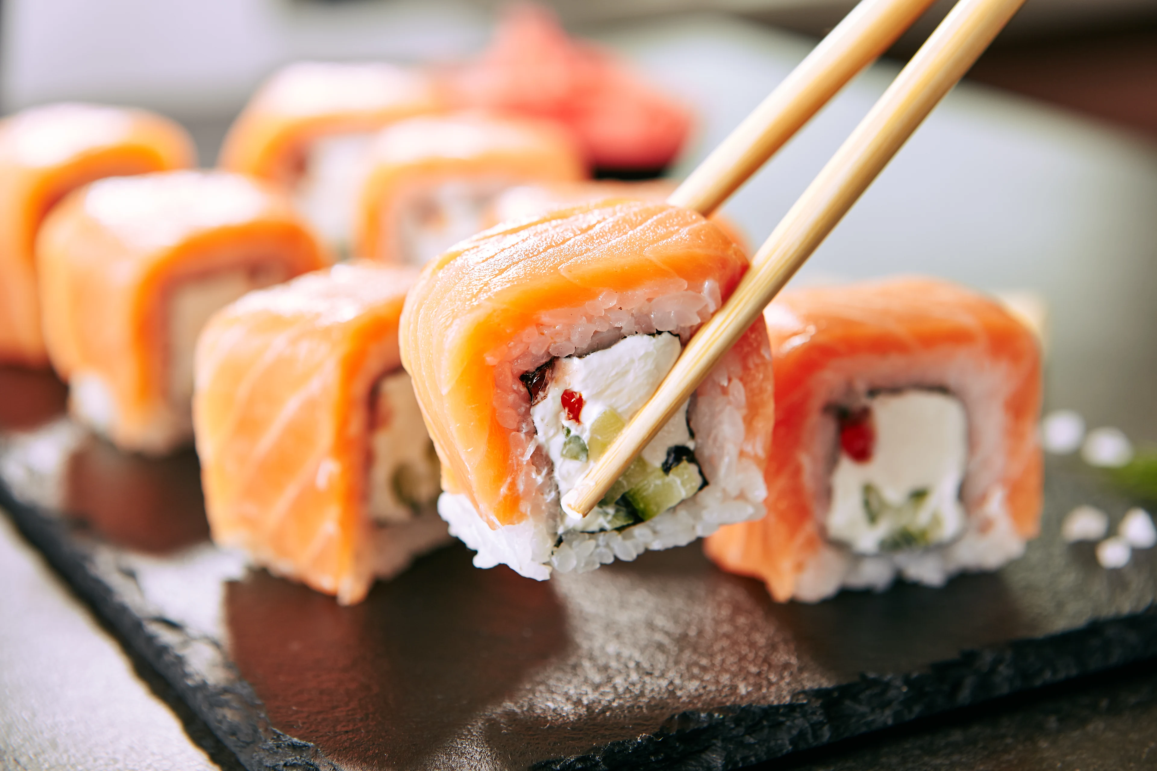 Sushi med laks og friske råvarer serveret på en restaurant i Japan, en populær del af den japanske madkultur.