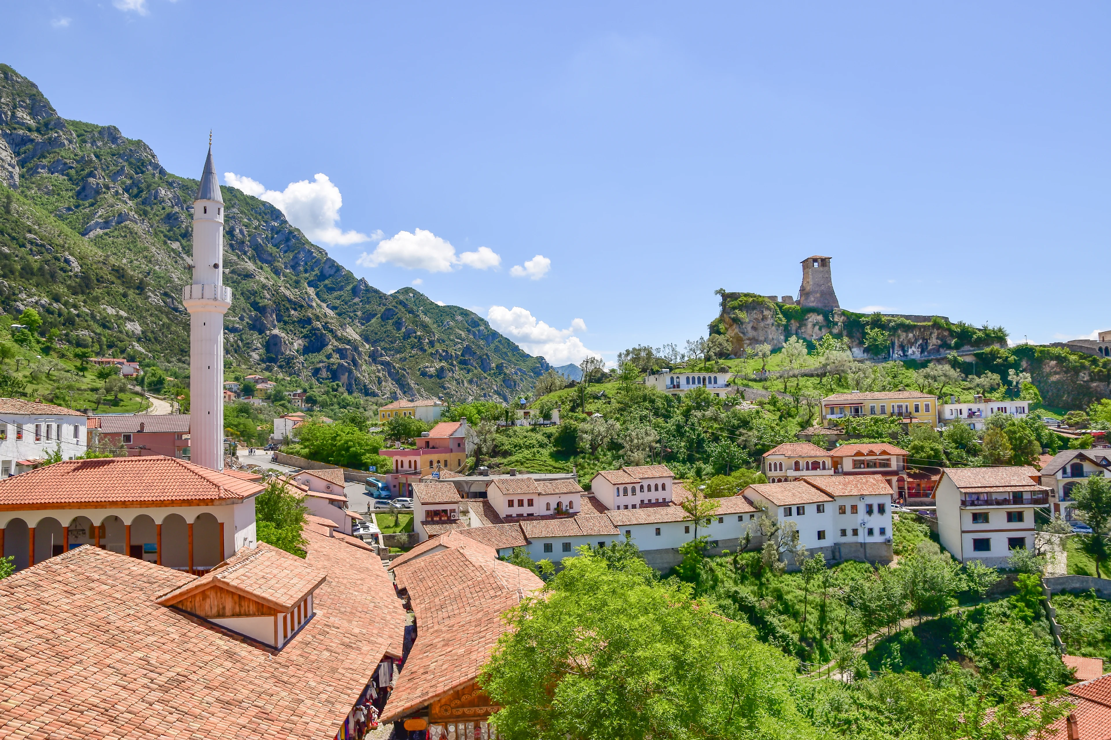 uitzicht op de stad Kruja in de bergen met stenen huizen en een kasteel erop