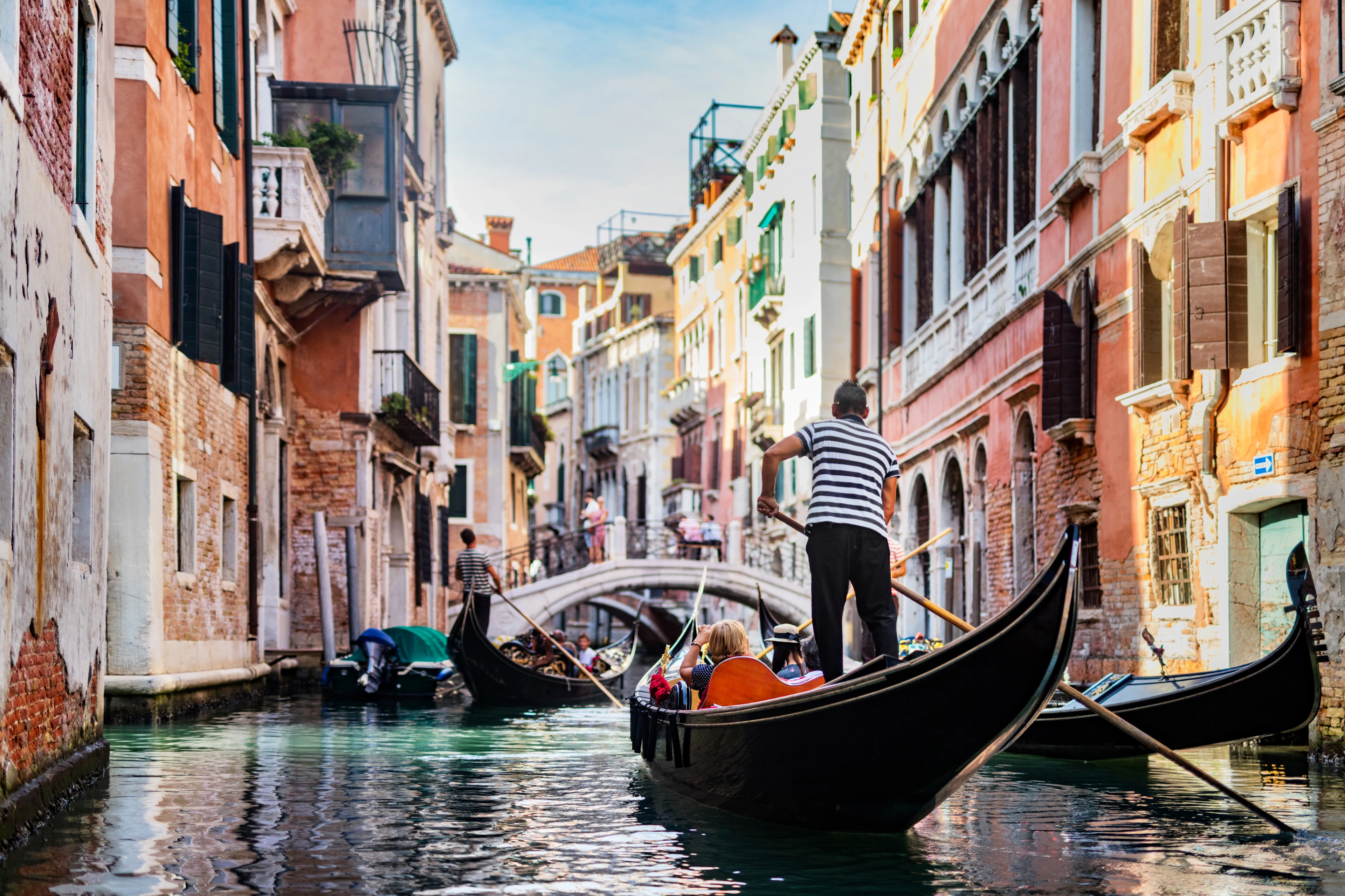En gondol i en vacker kanal omgiven av färgglada hus i Venedig