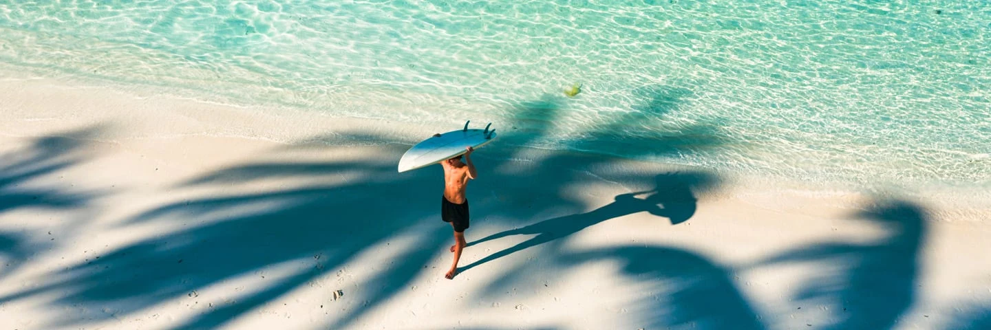 Man with surfing board on beach