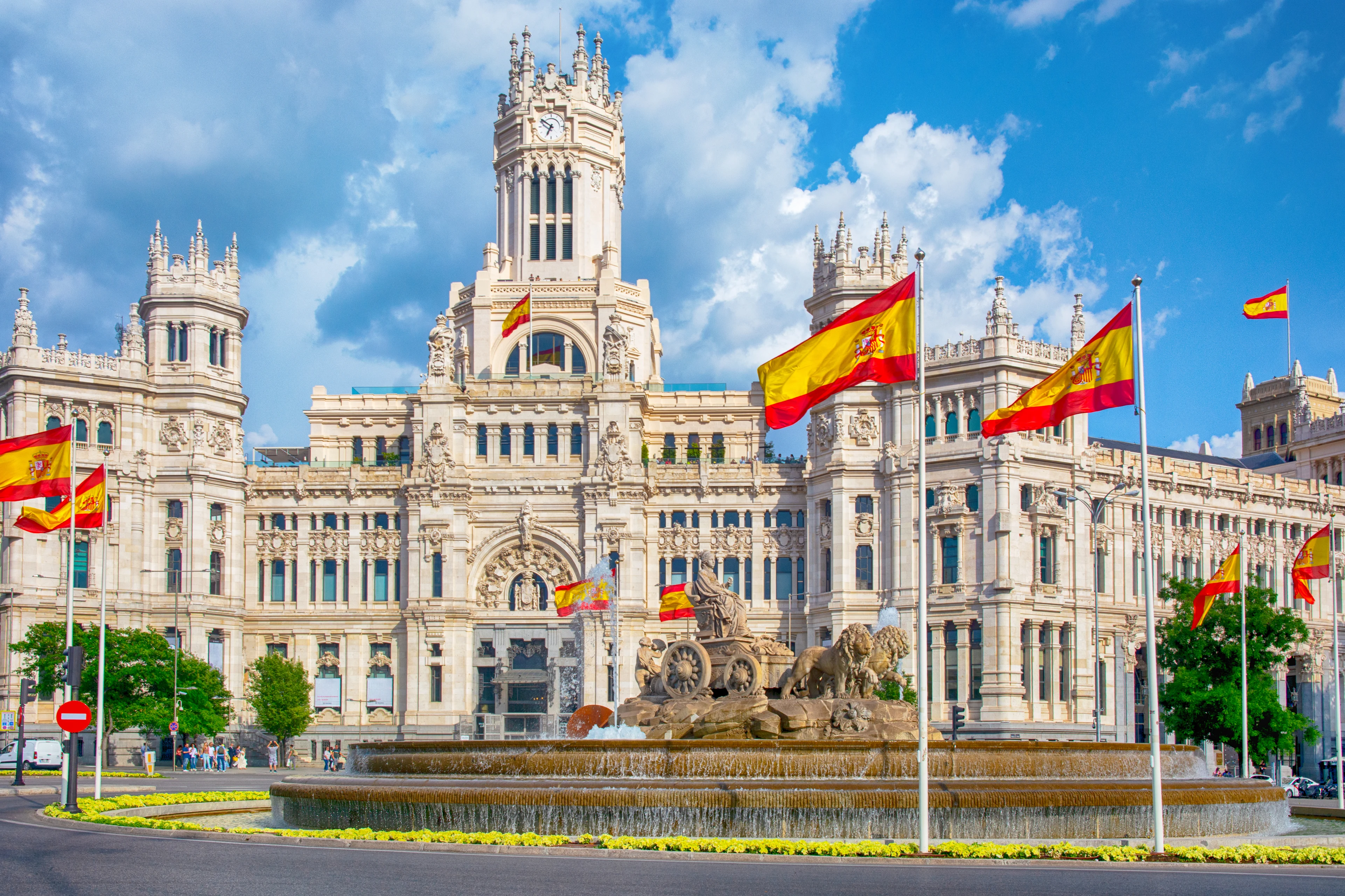 Flaggor vajar utanför Plaza de Cibeles i Madrid