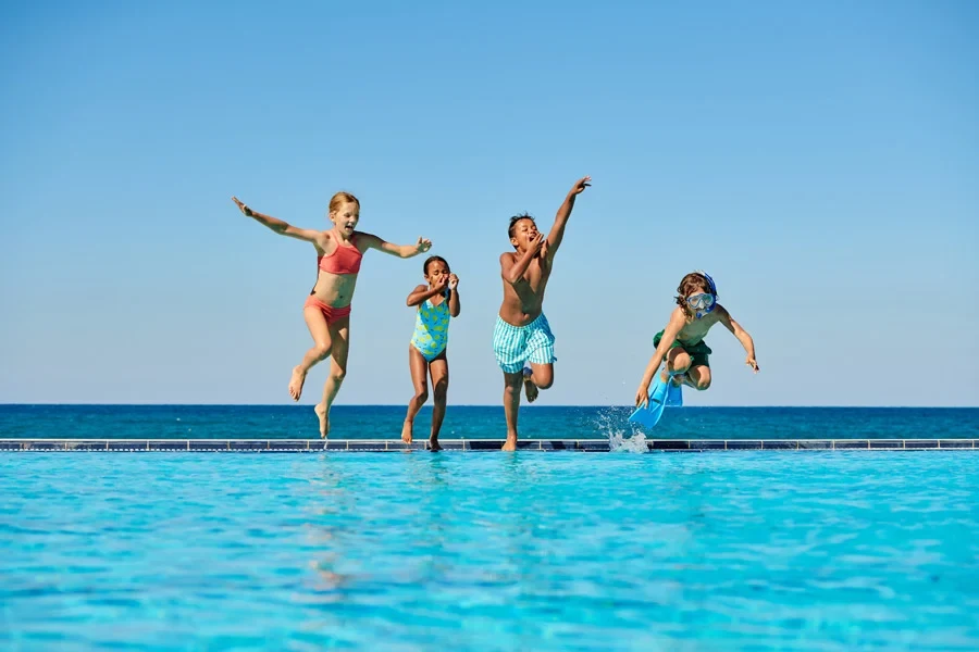 Barnen hoppar i poolen