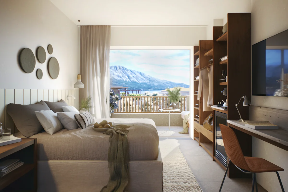 Rum med dubbelsäng och vacker utsikt över bergen och havet på hotellet Seagonia i Paleros