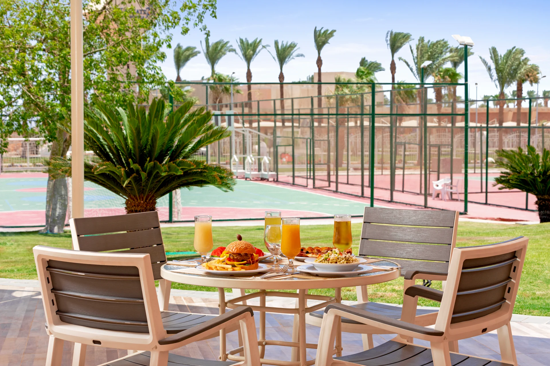 Hamburgare och dryck på ett uppdukat bord på Pickalbatros Aqua Park Resort i Hurgahda