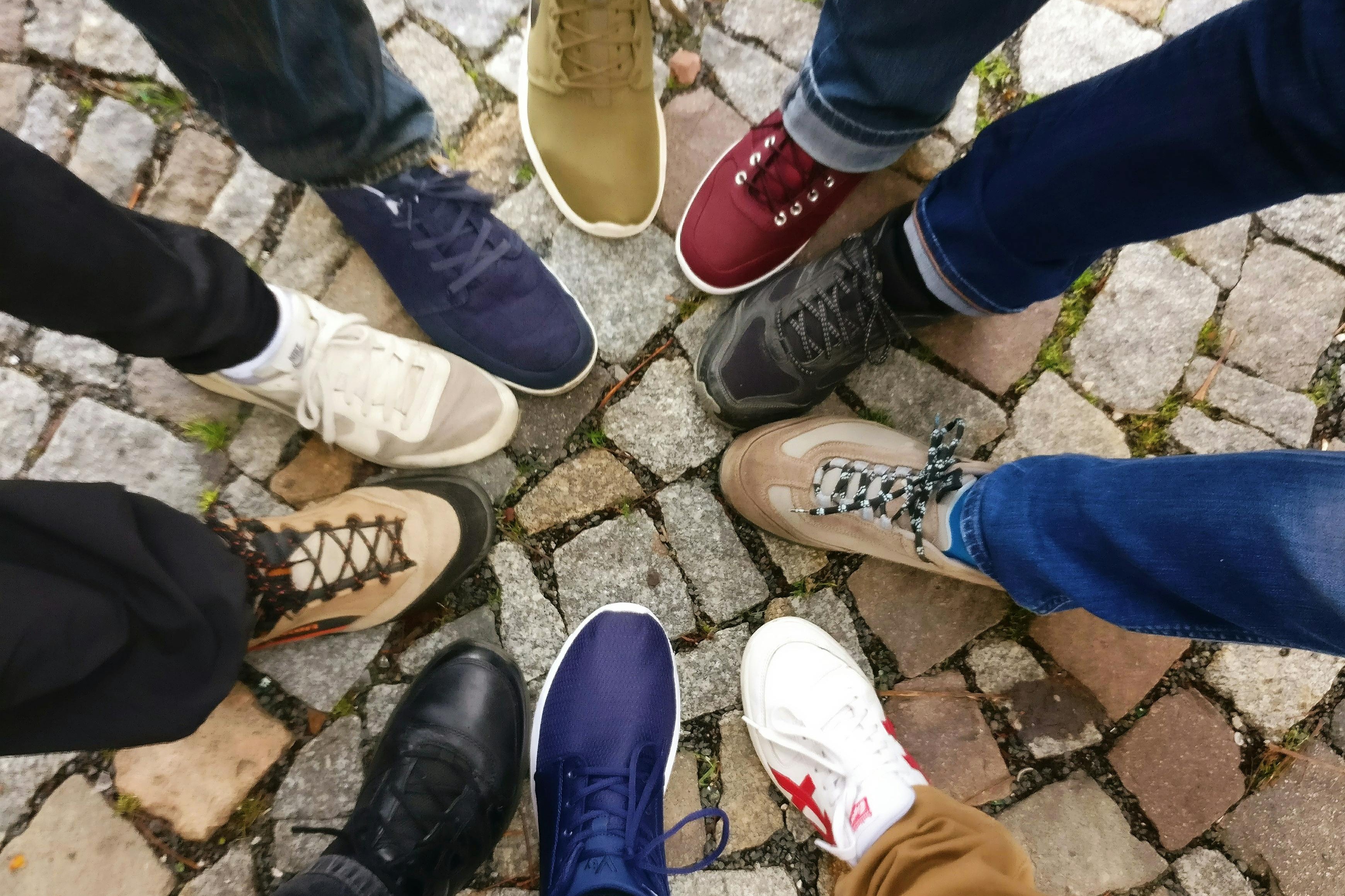 People standing together, one foot in a circle