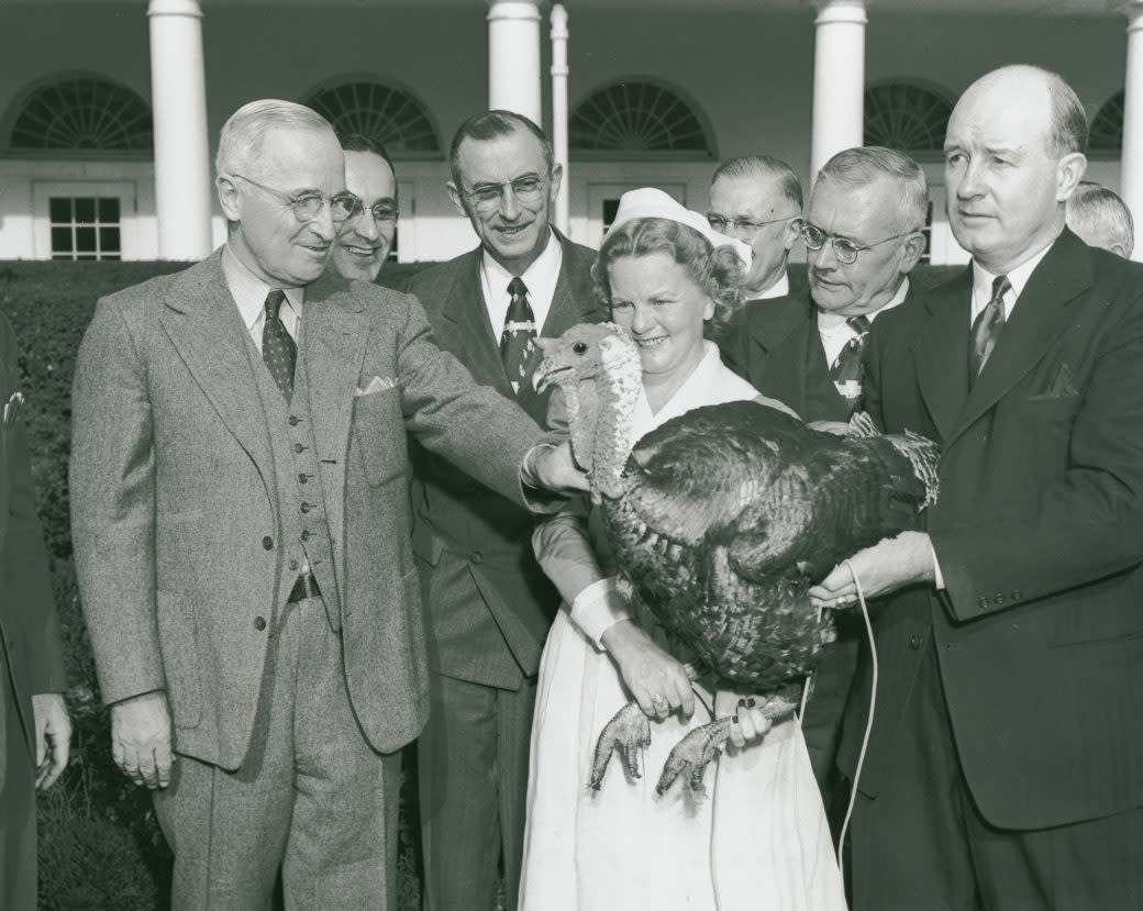 President Harry S. Truman pardons a Turkey in the White House Rose Garden.