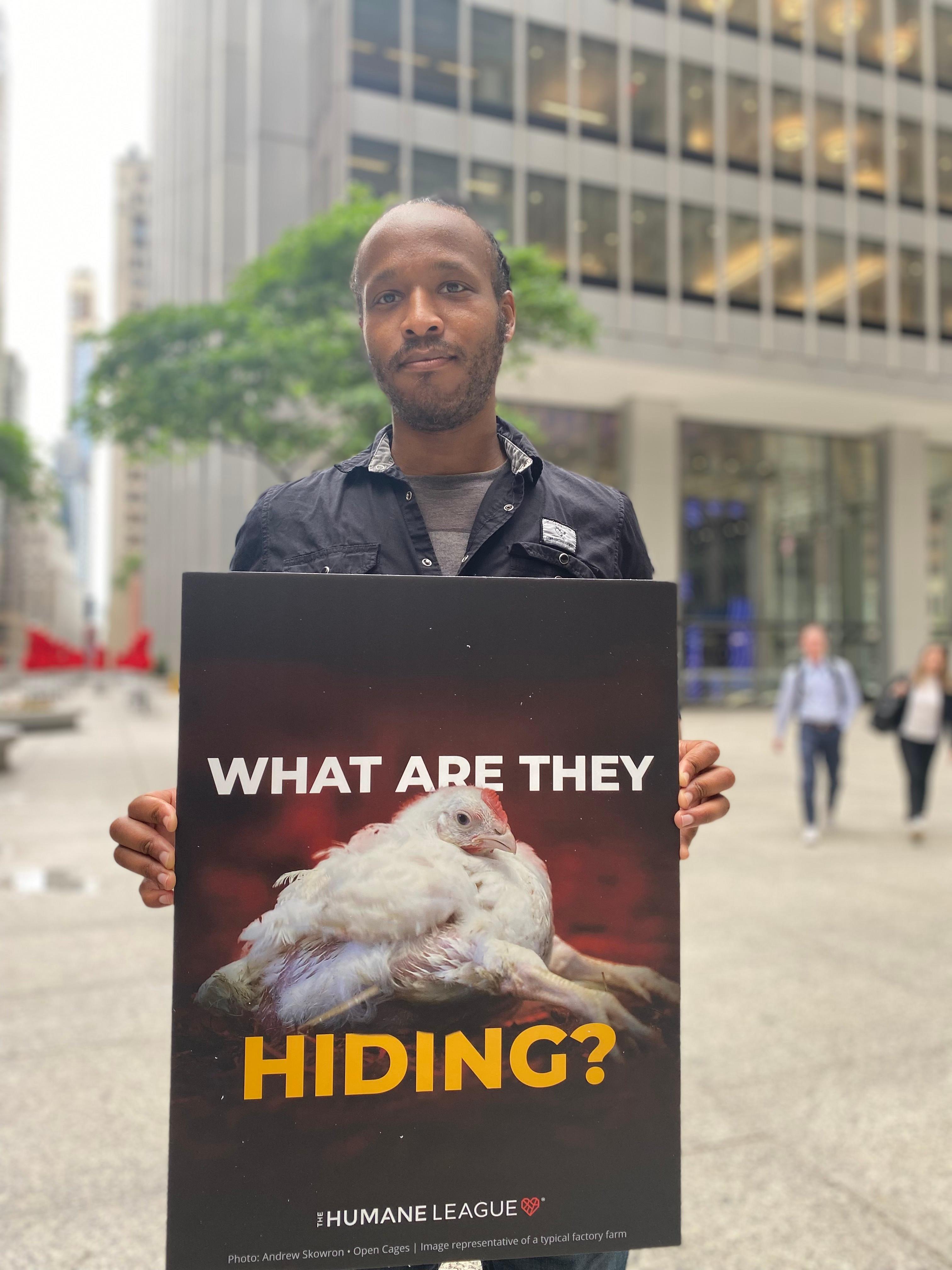 Protester holds a sign that reads: What are they hiding?