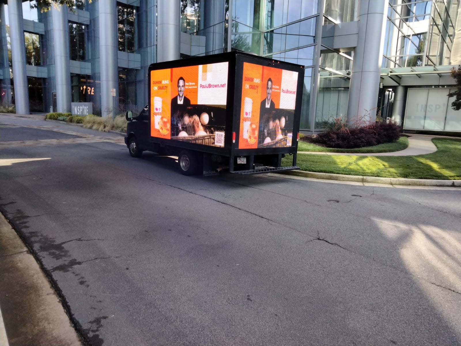 Truck with mobile billboard outside of office building