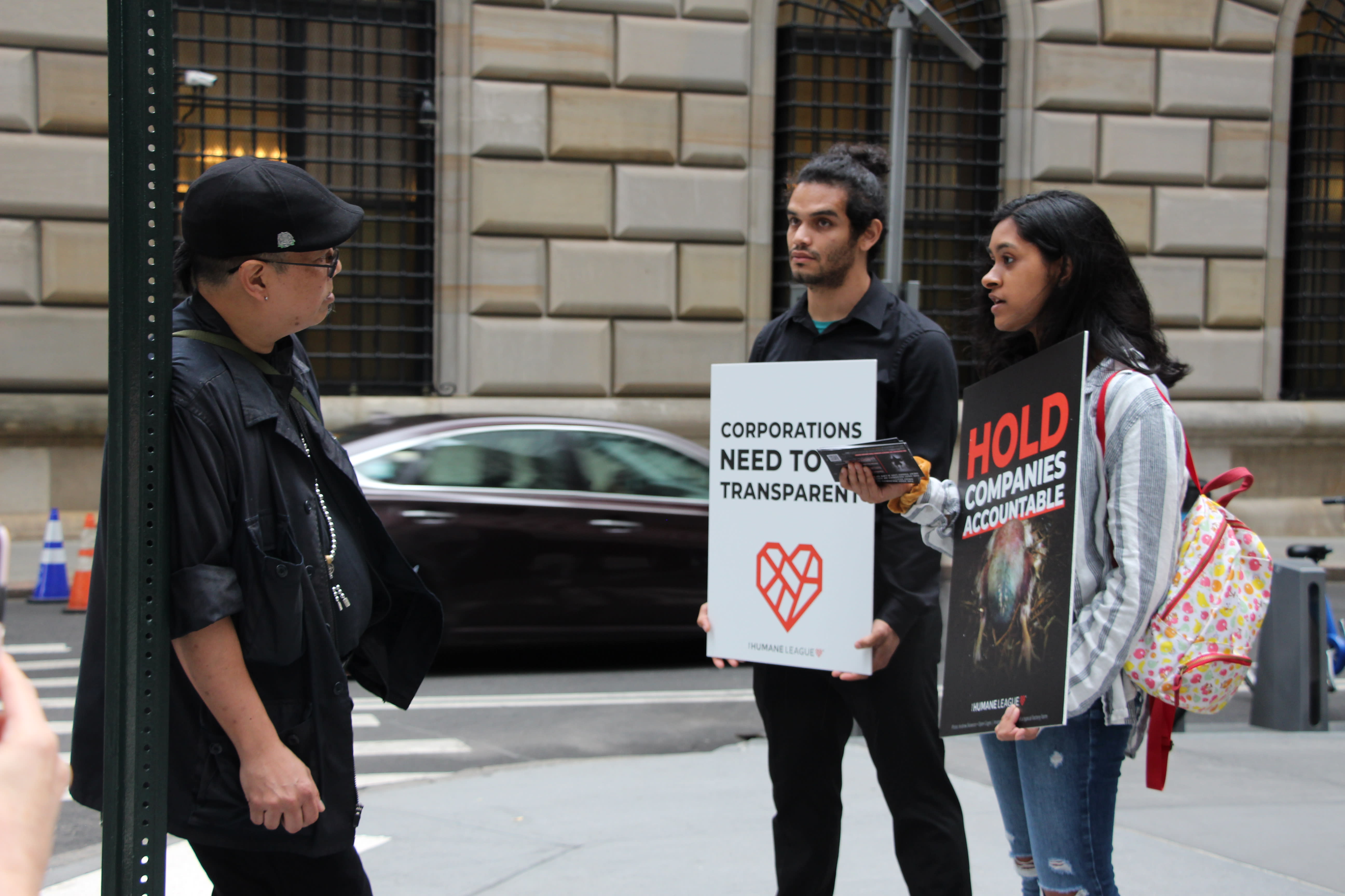 Protesters engage with a passerby on animal welfare issues