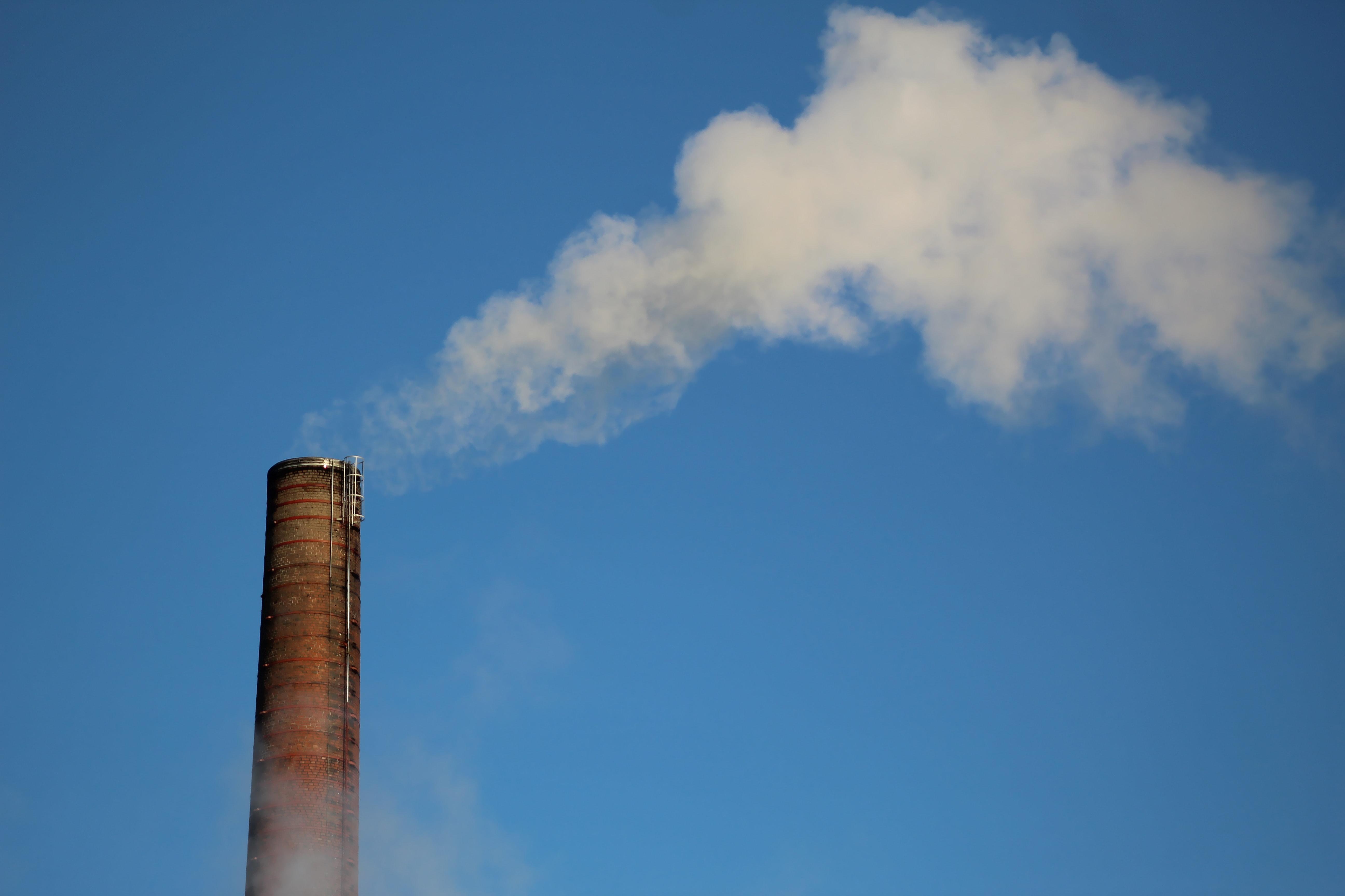 Smokestack emitting gas into the sky