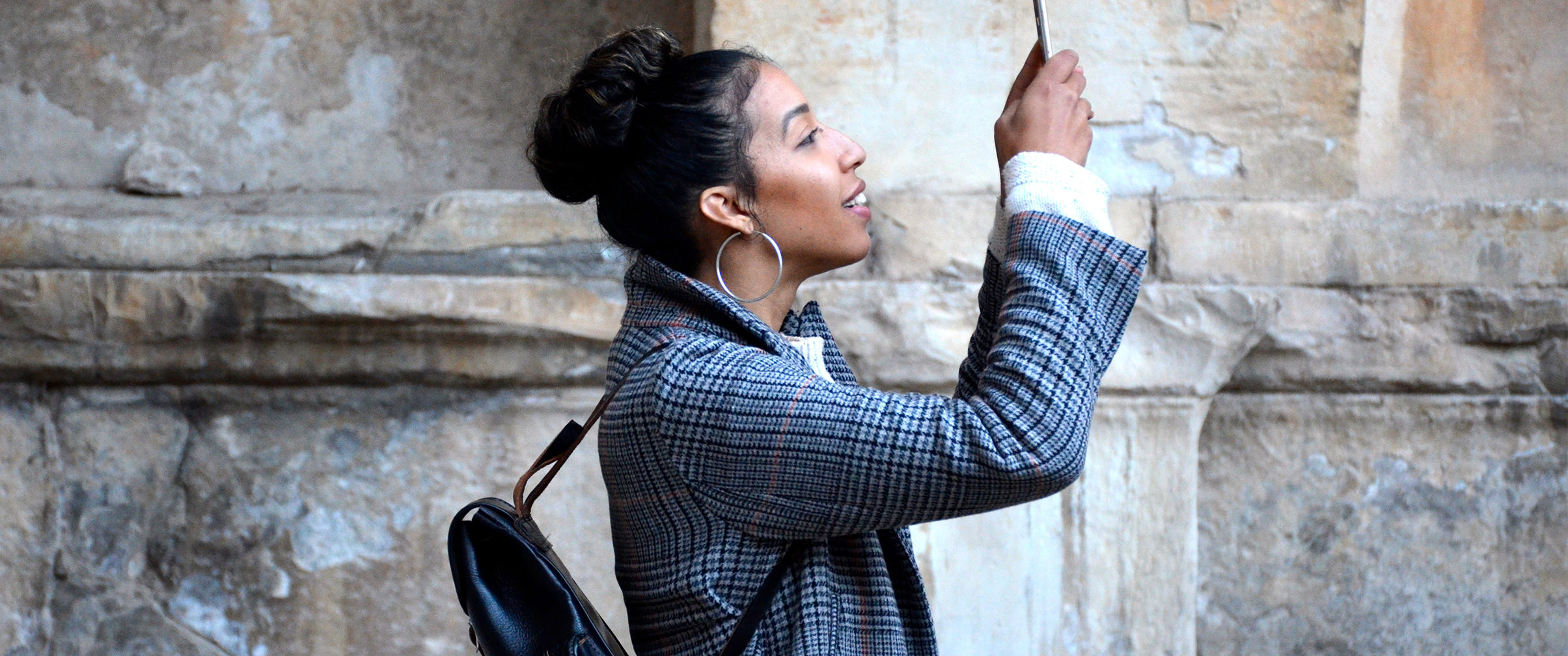 Woman in taking a photo using her phone