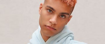 A young man with bright hair in hoodies