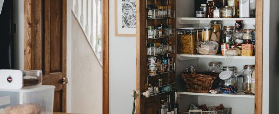 A storage cupboard full of food jars