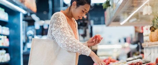 Woman choosing apples in a supermarket