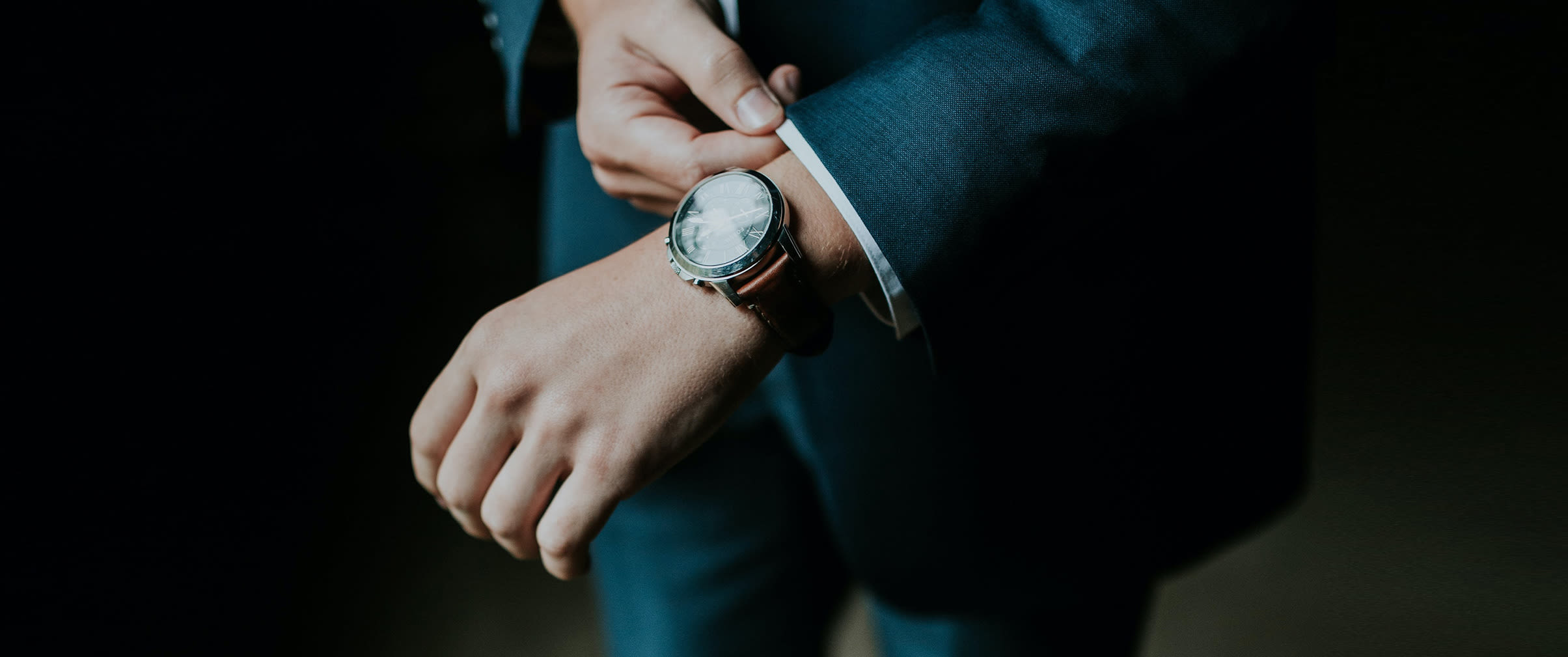 Wristwatch worn by a person in a formal suit