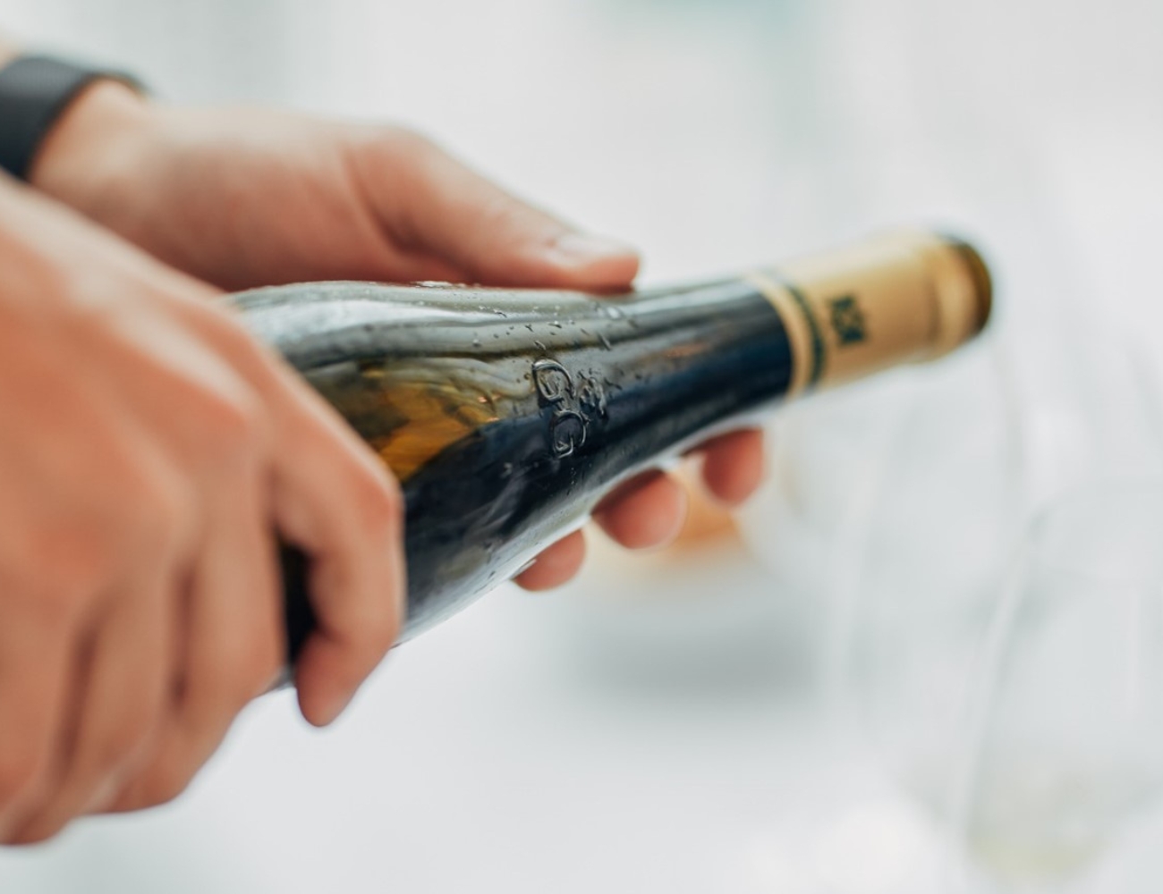holding wine bottle