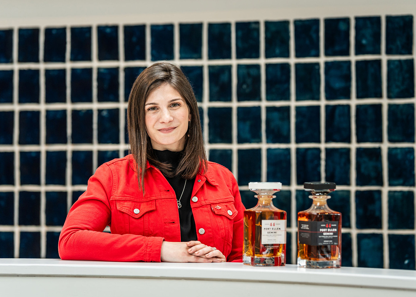 Aimée Morrison, Master Blender beside two bottles of Port Ellen Gemini