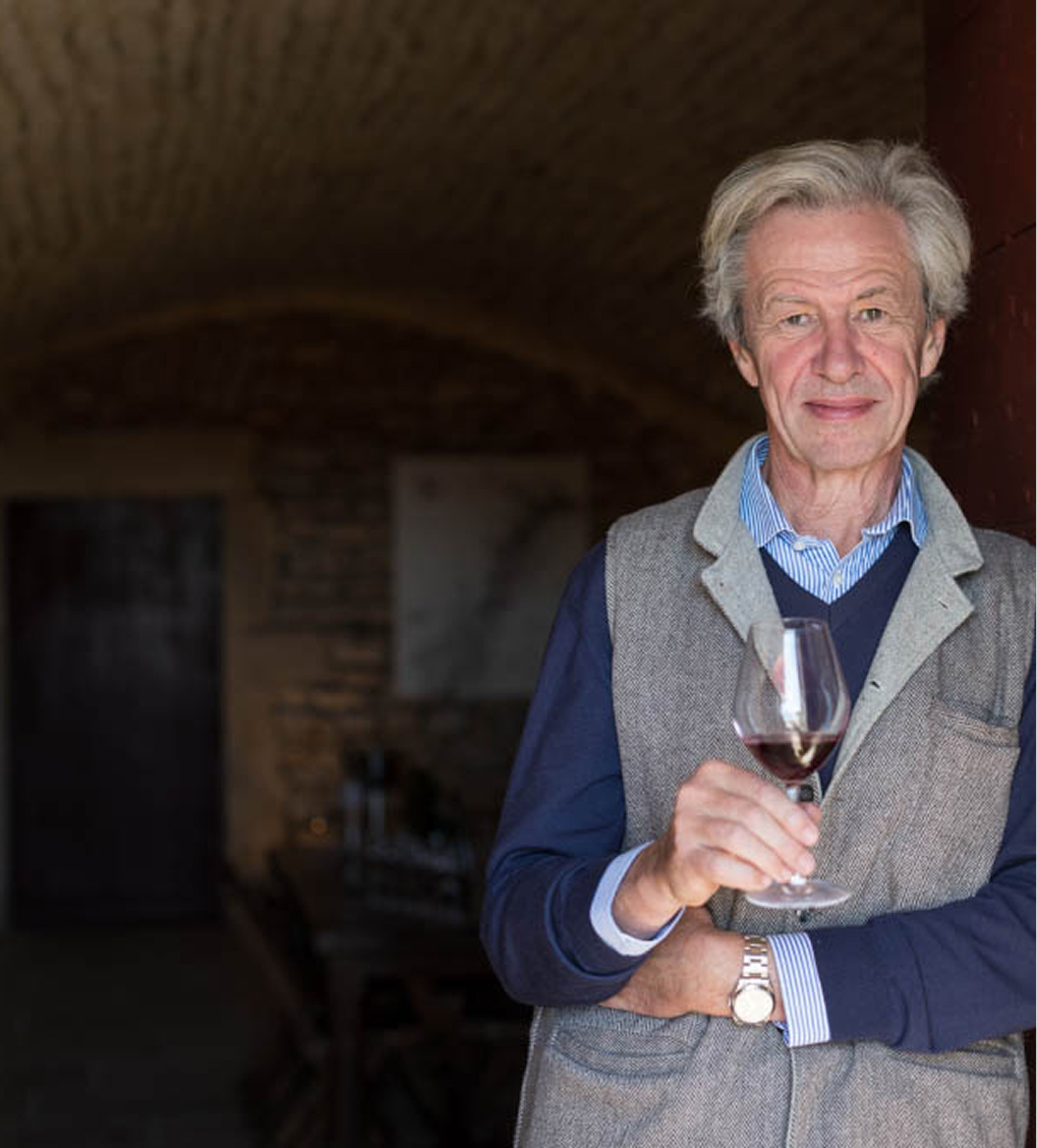 Marquis d'Angerville holding a red wine