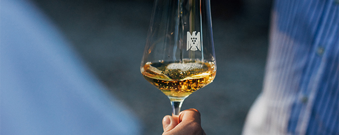 A person holding a white wine