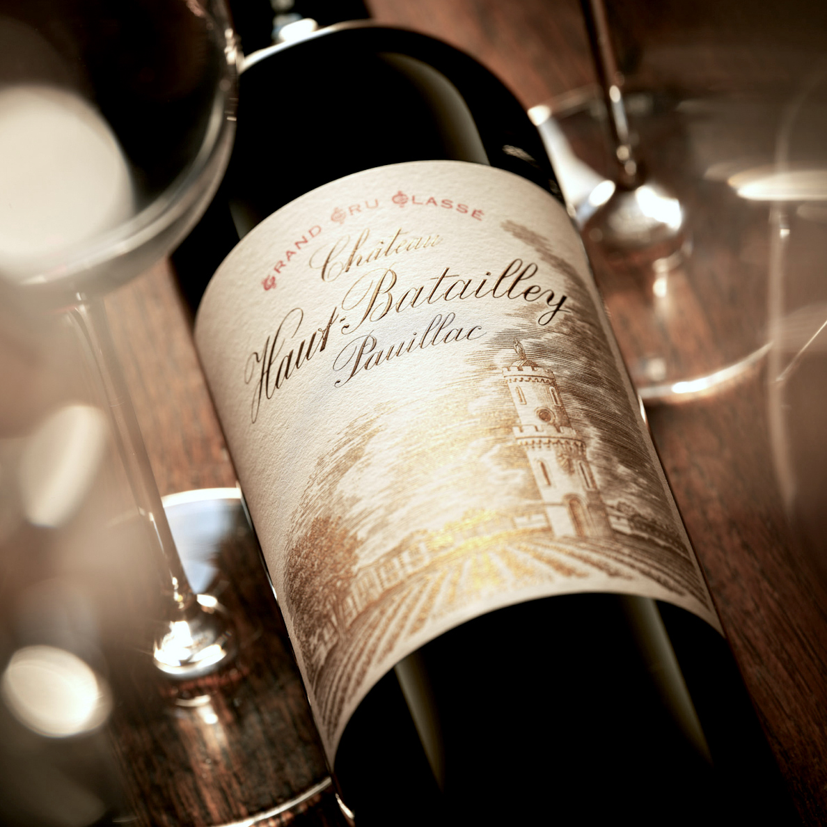 A bottle of of Pauillac wine lying down on a table