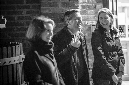 A group of people chatting in black and white