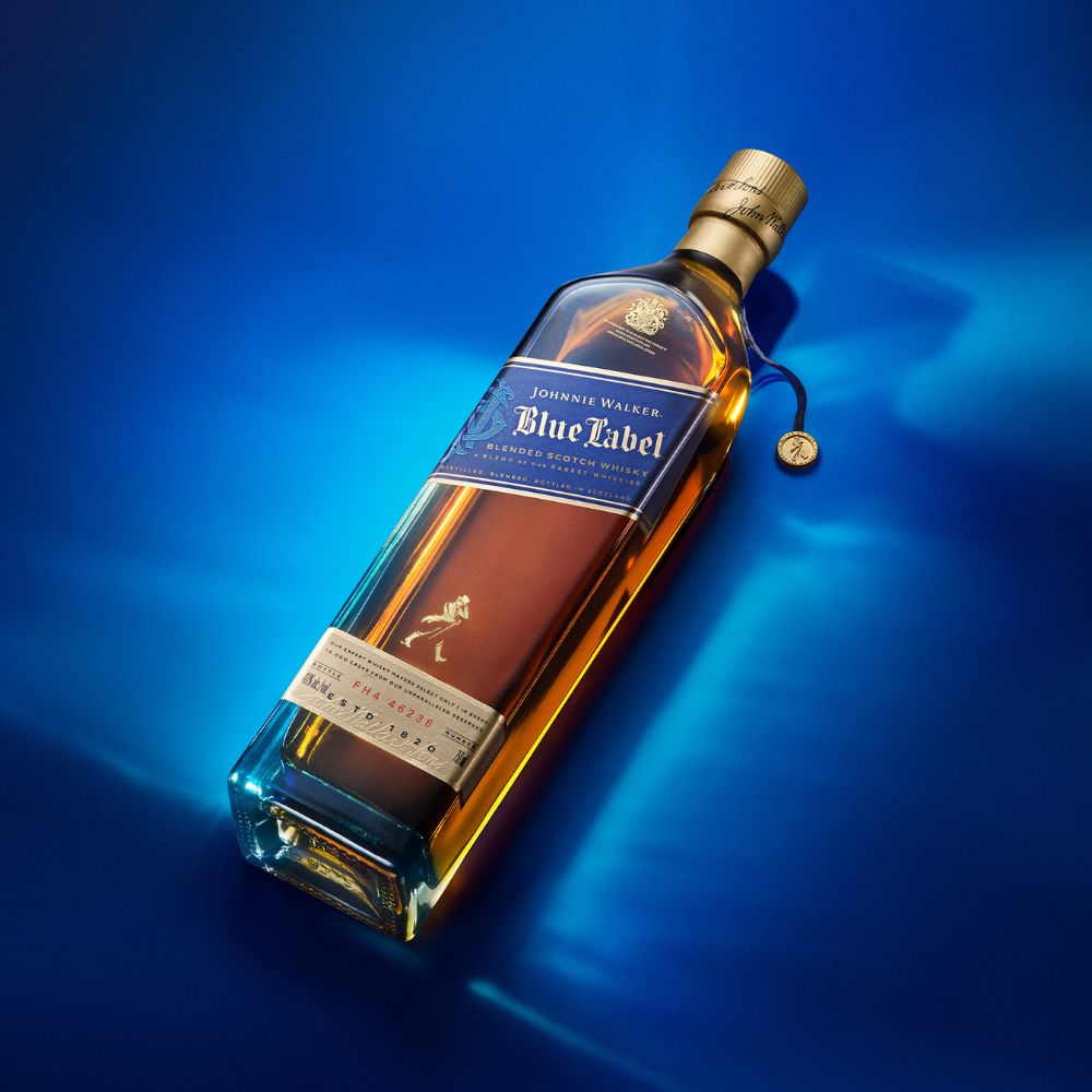 Whisky bottle on blue background