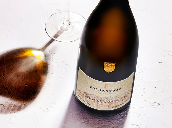 A bottle of Philipponnat with a wine glass beside it