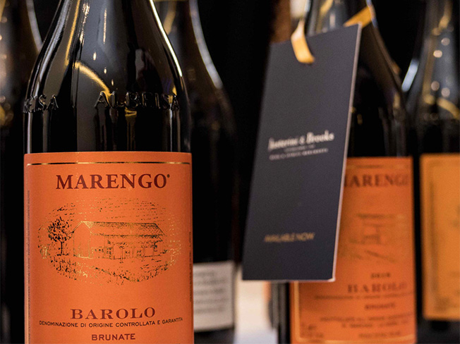 Bottle of Marengo Barolo Wines with orange labels and a Justerini & Brooks label ribboned around a neck of a bottle