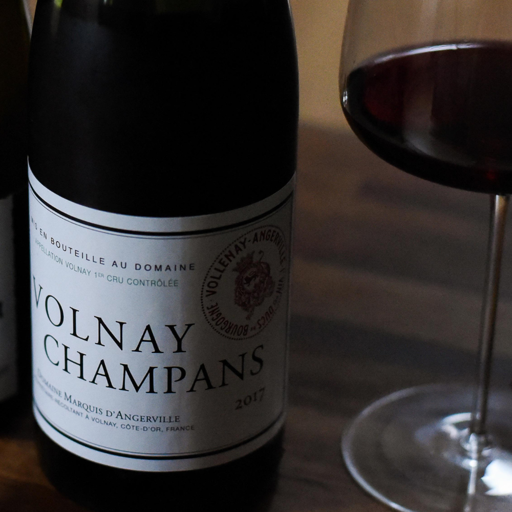 bottle of wine next to red wine glass