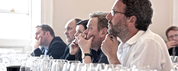 people lined up at a tasting looking in the same direction