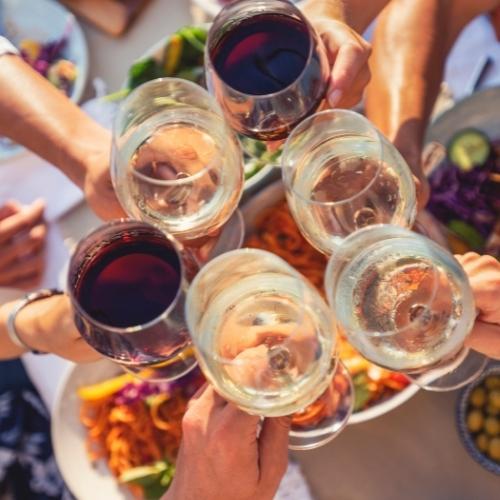 cheers with glasses of white and red wine