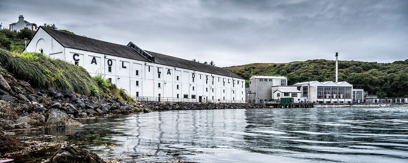 Outside the Caol Islay distillery near a body of water