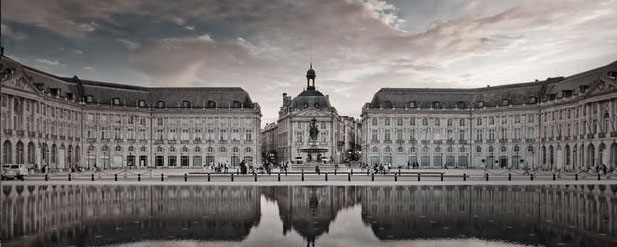 exterior of large building with fountain at front