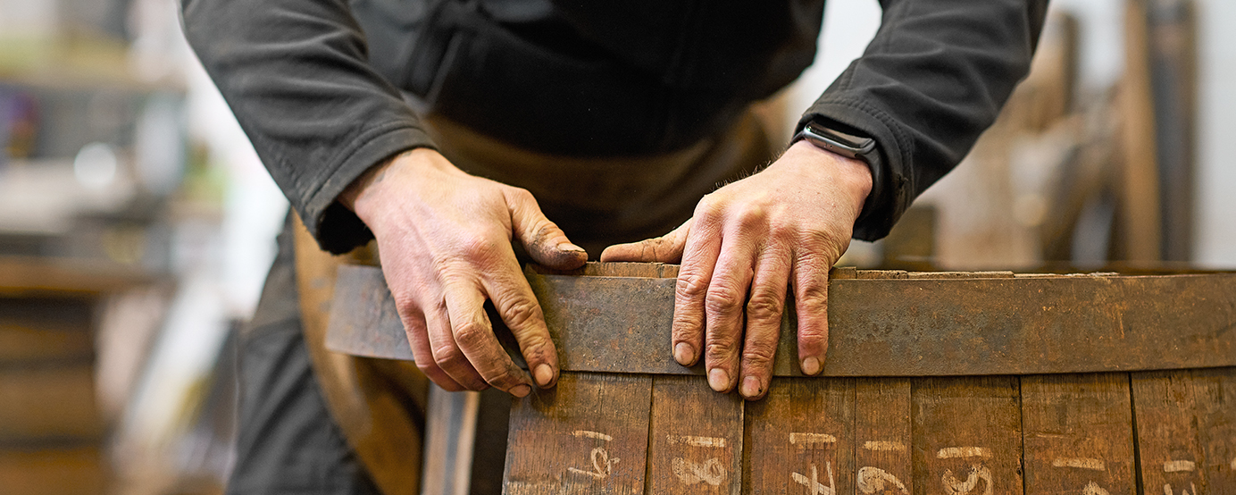 A person putting together a cask for whiskies