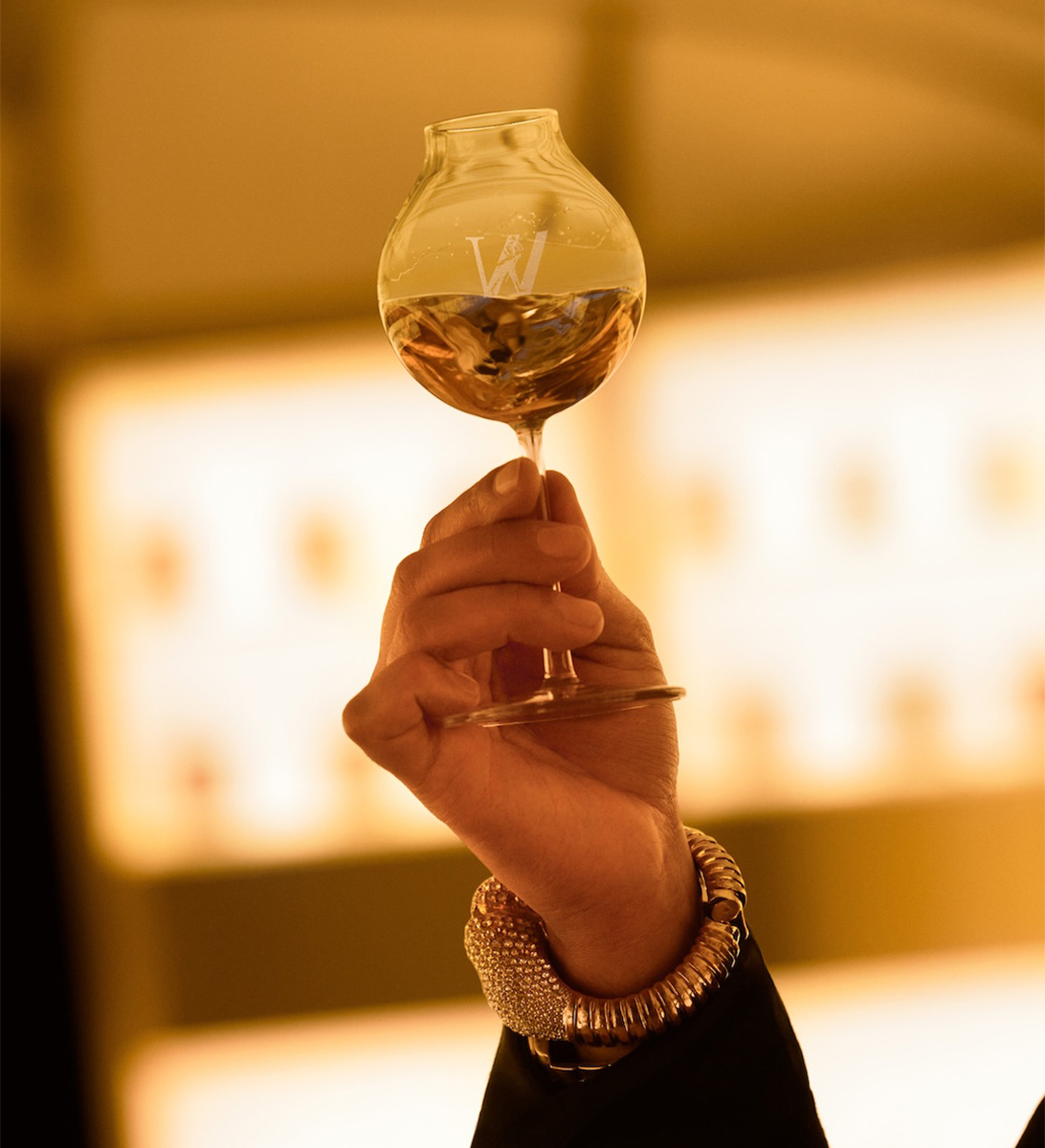 Olivier Rousteing holding a glass of whisky