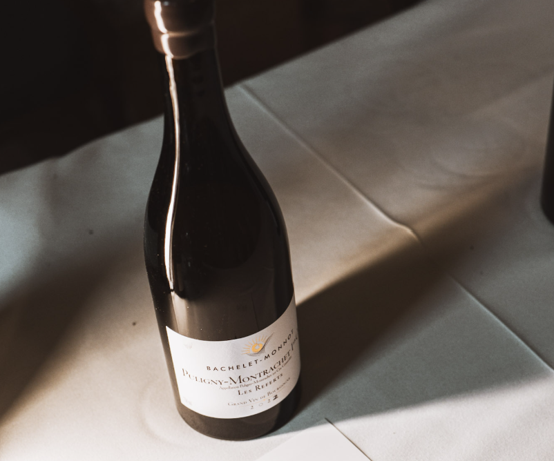 A single bottle of wine on a white tablecloth, Hidden Gems