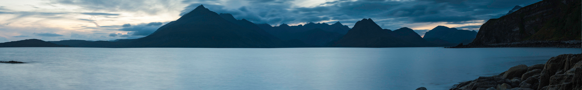 rolling hills scenery with lake in the background