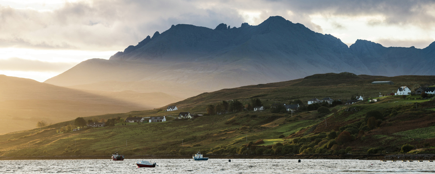 Mountain beside a body of water near the Talisker distillery