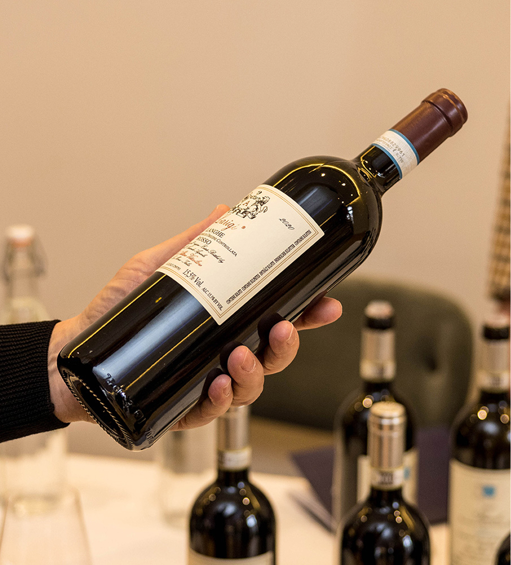A person holding a wine bottle