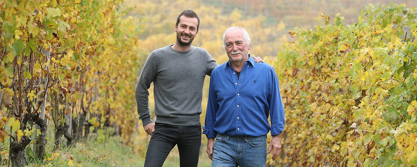 Two men standing in a vineyard