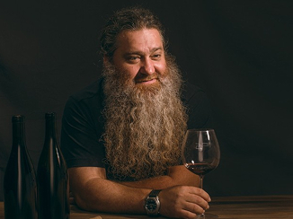 Raúl Pérez holding a wine
