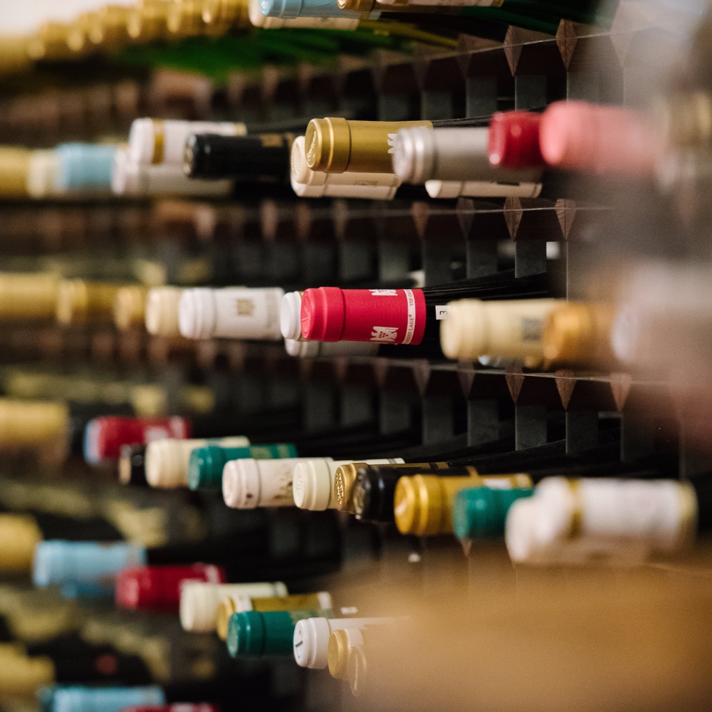 Several wines stacked on a shelf
